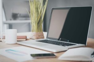 Espacio de trabajo moderno con portátil y dispositivos digitales asociado a soluciones tecnológicas